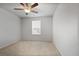 Comfortable carpeted bedroom with a ceiling fan and window allowing for natural light at 5 Dew Drop Pt, Dallas, GA 30157