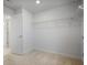 Walk-in closet with wire shelving, neutral carpet, and an open doorway at 5 Dew Drop Pt, Dallas, GA 30157
