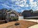 Gray home with white trim, attached garage, and nicely landscaped front yard at 5 Dew Drop Pt, Dallas, GA 30157