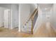 Hallway features wood floors leading to carpeted stairs with iron spindles and wood railing at 5 Dew Drop Pt, Dallas, GA 30157