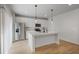 A bright kitchen featuring stainless steel appliances, white cabinets, light countertops, and an island with pendant lighting at 5 Dew Drop Pt, Dallas, GA 30157