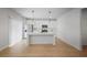 Modern white kitchen with stainless steel appliances, island, and hardwood flooring at 5 Dew Drop Pt, Dallas, GA 30157