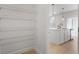 Pantry with several white racks off the kitchen with stainless steel appliances at 5 Dew Drop Pt, Dallas, GA 30157