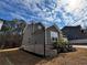 Charming side view of the house with gray siding and brick foundation at 5 Dew Drop Pt, Dallas, GA 30157