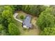Aerial view of the property highlighting its spacious backyard with fire pit area and adjacent wooded surroundings at 511 Laird Rd, Hiram, GA 30141