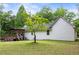 Side view of a beautiful backyard with a charming deck, mature trees, and well-maintained lawn at 511 Laird Rd, Hiram, GA 30141