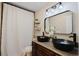 Bathroom with dual vessel sinks, granite countertop, and farmhouse lighting at 511 Laird Rd, Hiram, GA 30141
