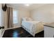 Bedroom with hardwood floors, white bedding, and natural light at 511 Laird Rd, Hiram, GA 30141