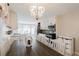 Bright dining room features a modern chandelier and a farmhouse dining table at 511 Laird Rd, Hiram, GA 30141