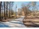 Long concrete driveway leading to the property, surrounded by mature trees at 511 Laird Rd, Hiram, GA 30141