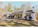 Charming white cottage-style home featuring a well-maintained lawn, shuttered windows and a welcoming front porch at 511 Laird Rd, Hiram, GA 30141