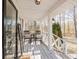 Inviting front porch with decorative welcome sign, rocking chairs, and lantern-style lighting for a cozy ambiance at 511 Laird Rd, Hiram, GA 30141