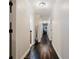 Long hallway with hardwood floors and neutral walls leads to various rooms in the house at 511 Laird Rd, Hiram, GA 30141