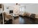Inviting living room with a stone fireplace, hardwood floors, neutral color scheme and a ceiling fan for added comfort at 511 Laird Rd, Hiram, GA 30141
