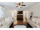 Bright living room featuring hardwood floors, two couches, stylish curtains, and a ceiling fan for a modern touch at 511 Laird Rd, Hiram, GA 30141