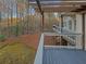 Back deck with wood pergola, grey decking, metal railing, and view of treed backyard at 2688 Kelly Cove Dr, Buford, GA 30519