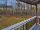 View from the back deck with wooden pergola, metal railing, and treed backyard at 2688 Kelly Cove Dr, Buford, GA 30519