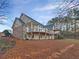 Back exterior of the home showing tiered decks and wooded backyard at 2688 Kelly Cove Dr, Buford, GA 30519