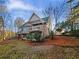 Back exterior of home with multiple decks and a pergola overlooking the treed yard at 2688 Kelly Cove Dr, Buford, GA 30519