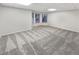 Spacious finished basement featuring neutral carpet, bright lighting, and two large windows at 2688 Kelly Cove Dr, Buford, GA 30519