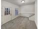 Finished basement area with neutral carpet, bright lighting, and walkout access to the exterior at 2688 Kelly Cove Dr, Buford, GA 30519