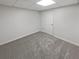 Finished basement area with neutral carpet, bright lighting, and painted white walls at 2688 Kelly Cove Dr, Buford, GA 30519