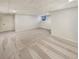 Spacious finished basement with neutral carpet, bright lighting, and freshly painted white walls at 2688 Kelly Cove Dr, Buford, GA 30519