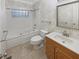 Well-lit bathroom with jacuzzi tub, tiled floor, and decorative mirror at 2688 Kelly Cove Dr, Buford, GA 30519
