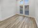Bedroom with large windows providing ample natural light and hardwood floors at 2688 Kelly Cove Dr, Buford, GA 30519
