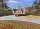 Beautiful brick home with a long driveway, attached garage, and lush green landscaping at 2688 Kelly Cove Dr, Buford, GA 30519