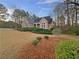Attractive brick home with a manicured front lawn and a variety of mature plantings at 2688 Kelly Cove Dr, Buford, GA 30519