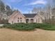 Charming pink brick home featuring manicured landscaping and a welcoming front porch at 2688 Kelly Cove Dr, Buford, GA 30519