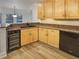 Kitchen with a breakfast bar and wood cabinets, perfect for entertaining guests at 2688 Kelly Cove Dr, Buford, GA 30519