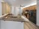 Eat-in kitchen features granite countertops, black appliances, and wood cabinetry at 2688 Kelly Cove Dr, Buford, GA 30519