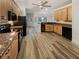 Spacious kitchen featuring granite countertops, wood cabinetry, and black appliances at 2688 Kelly Cove Dr, Buford, GA 30519