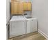 Laundry room with a washer, dryer and upper cabinets at 2688 Kelly Cove Dr, Buford, GA 30519