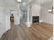 Spacious living room with hardwood floors, a fireplace, and elegant columns at 2688 Kelly Cove Dr, Buford, GA 30519