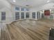Bright, open living room with lots of windows, hardwood floors, and built-in shelving at 2688 Kelly Cove Dr, Buford, GA 30519