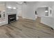 Open concept living room with hardwood floors and fireplace at 2688 Kelly Cove Dr, Buford, GA 30519