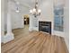 Living room featuring wood floors, fireplace, and elegant columns at 2688 Kelly Cove Dr, Buford, GA 30519