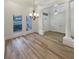 Bright living room boasts hardwood floors, large windows and decorative chandelier at 2688 Kelly Cove Dr, Buford, GA 30519