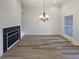 Bright living room with hardwood flooring, modern fireplace and decorative chandelier at 2688 Kelly Cove Dr, Buford, GA 30519