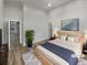 Bright main bedroom boasts hardwood floors, high ceilings and light neutral walls at 2688 Kelly Cove Dr, Buford, GA 30519