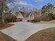 Brick home with attached garage and a long driveway surrounded by mature trees at 2688 Kelly Cove Dr, Buford, GA 30519