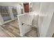 Carpeted stairs with white railing, window lighting, and wood flooring at 2688 Kelly Cove Dr, Buford, GA 30519