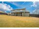 Large backyard with an expansive lawn, stone fireplace, and screened-in porch at 4030 Amberhill Cir, Cumming, GA 30040