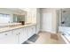 Modern bathroom with double sinks, granite countertops, and a glass-enclosed shower and soaker tub at 4030 Amberhill Cir, Cumming, GA 30040