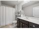 Modern bathroom with a shower, vanity with a white countertop, and a storage shelf for linens and toiletries at 4030 Amberhill Cir, Cumming, GA 30040