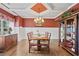 Formal dining room with a coffered ceiling, chandelier, wainscoting and elegant decor at 4030 Amberhill Cir, Cumming, GA 30040