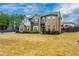 Beautiful, well-maintained home with lush front lawn, landscaped shrubs, and a circular driveway at 4030 Amberhill Cir, Cumming, GA 30040
